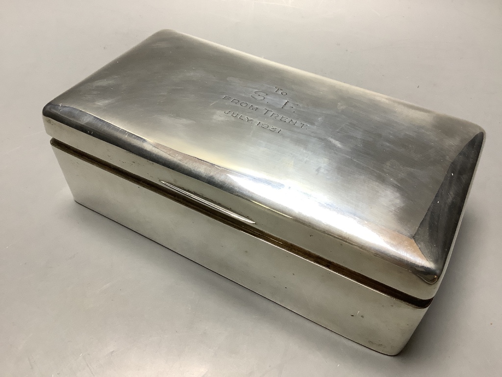 A 1930s silver rectangular cigarette box with engraved inscription.